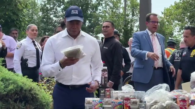 Mayor Eric Adams with NYPD officers at a contraband seizure event, New York City